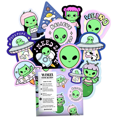 Collection of colorful alien-themed stickers with a Wimzi Stickers packaging in the center.
